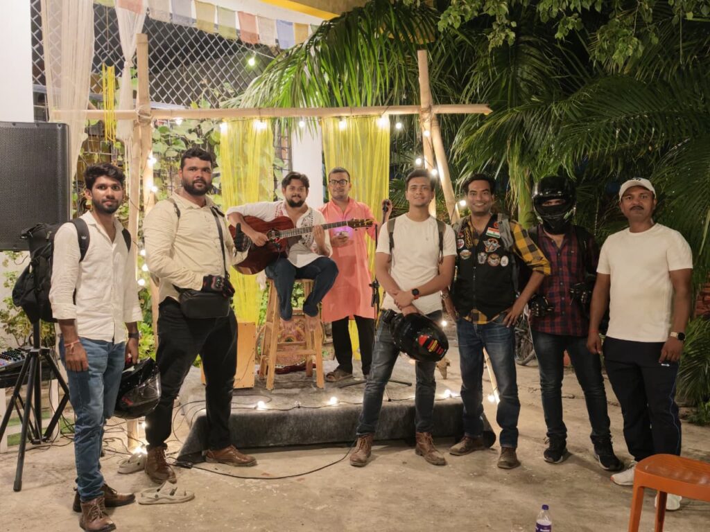 End of a full day — riders and the performer at Kitab Koffee Cafe, Bodh Gaya.