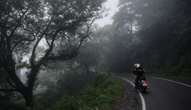 "Motorcyclist riding through monsoon rain on Indian highway"
